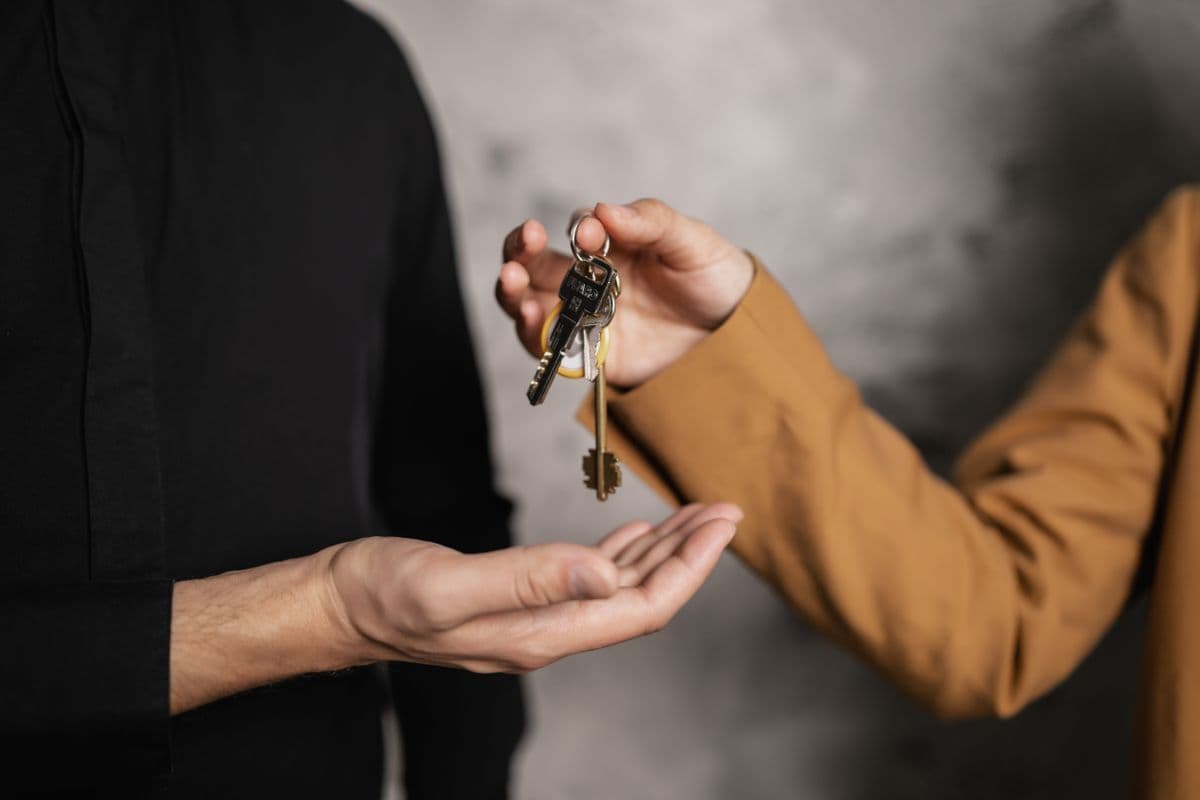 Host handing keys to a guest at check-in